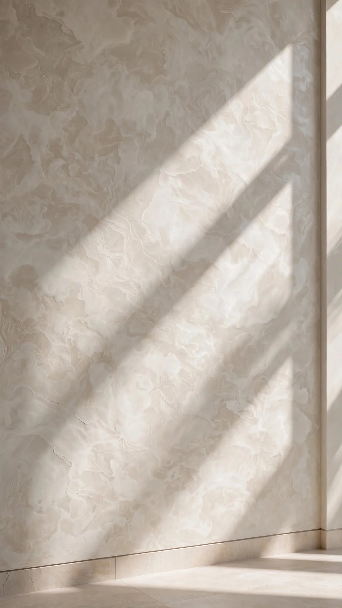 Hand-troweled Venetian plaster wall with warm alabaster tones and natural raking sunlight