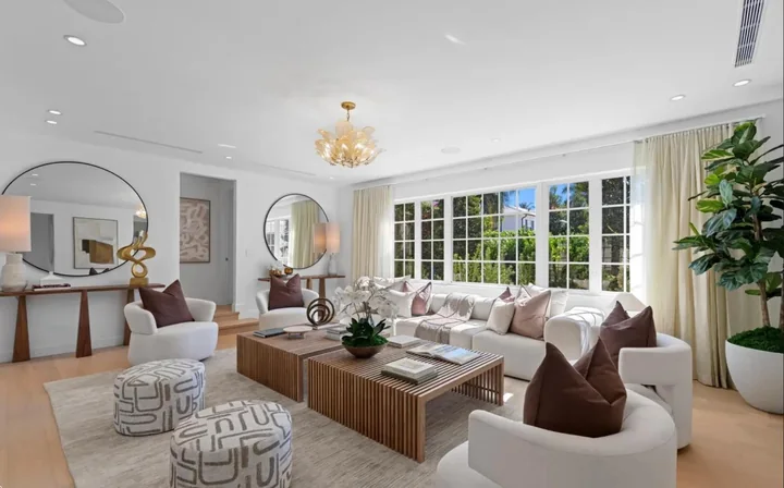 White living room with detailed ceilings and tall garden-facing windows