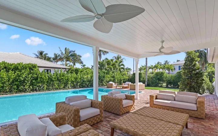 White beadboard terrace ceiling above seating beside a pool