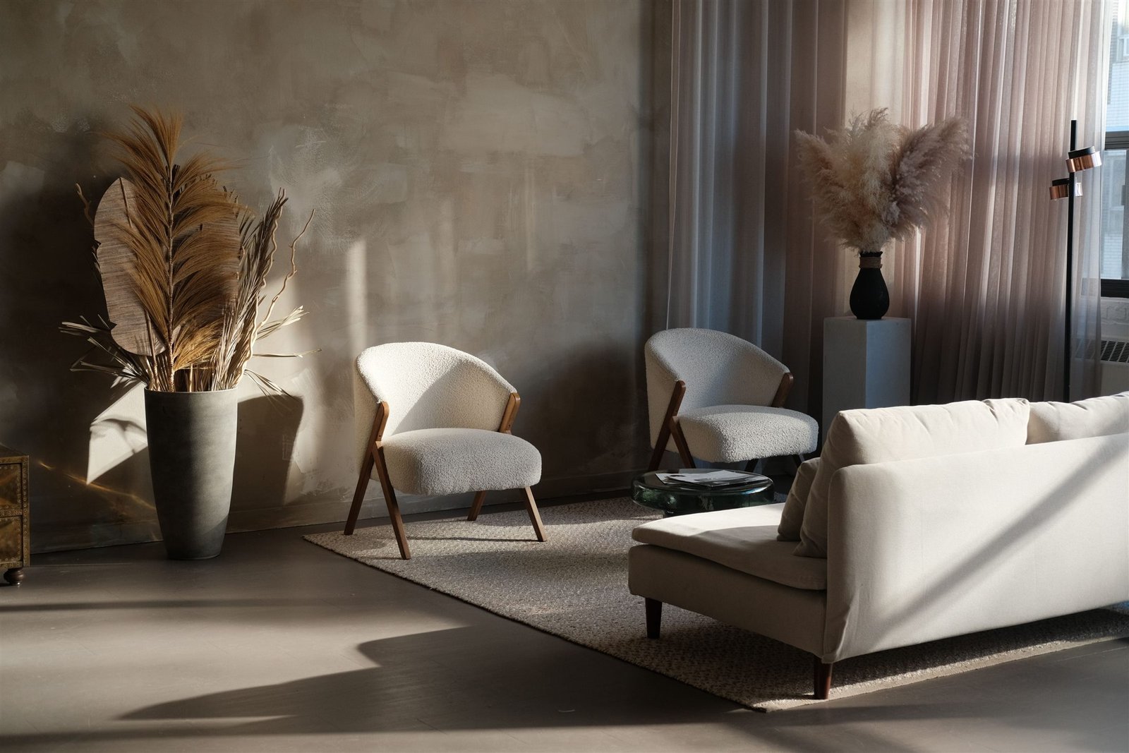 Sunlit living room with hand-finished plaster walls, sculptural seating, and warm natural materials