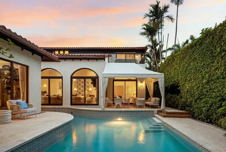 Pristine floor and exterior architecture around swimming pool at sunset